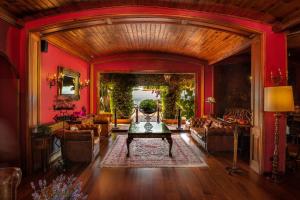 a living room with red walls and a table at Rigat Park & Spa Hotel - Adults Recommended in Lloret de Mar