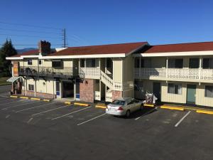 a car parked in a parking lot in front of a building at Port Angeles Inn in Port Angeles