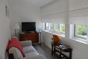 a living room with a couch and a tv at Madre Deus Guest House in Lisbon