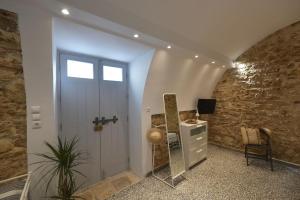 a hallway with a door and a mirror and a desk at Yiasemi Corfu Luxury Studio in Corfu