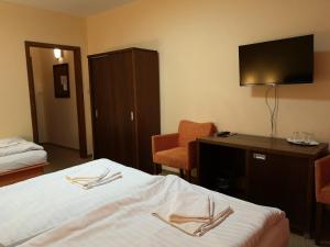 Postel nebo postele na pokoji v ubytování Garni Hotel Cosmopolitan