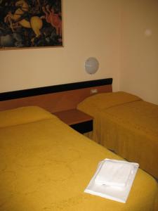 Postel nebo postele na pokoji v ubytování Albergo Paradiso