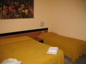 Postel nebo postele na pokoji v ubytování Albergo Paradiso