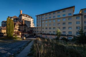 a group of buildings next to a street at Apartman Smokovec in Smokovce