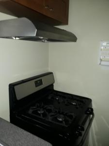 a stove in the corner of a kitchen at Jacaranda Homes in Spanish Town