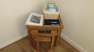 een kleine tafel met een toetsenbord en een mand erop bij Stouts Court Apartment in Lerwick