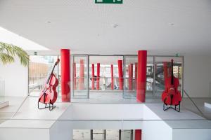 two red guitars are on display in a building at Hotel da Música in Porto