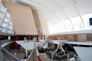 a large building with white tables and a large ceiling at Hotel da Música in Porto