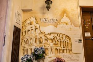 a painting of the leaning tower of colossus on a wall at RomAntic Dreams in Rome