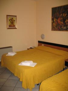 Postel nebo postele na pokoji v ubytování Albergo Paradiso