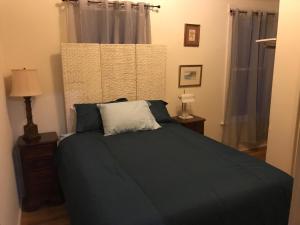 a bedroom with a bed and two lamps and a window at Ocean Breeze 3 br Vacation Home in Santa Barbara
