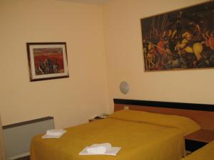 Postel nebo postele na pokoji v ubytování Albergo Paradiso
