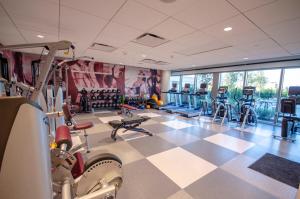 a gym with cardio equipment and a checkered floor at Texas A&M Hotel and Conference Center in College Station