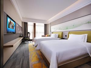 Ένα ή περισσότερα κρεβάτια σε δωμάτιο στο Hampton by Hilton Guangzhou Dongxiaonan