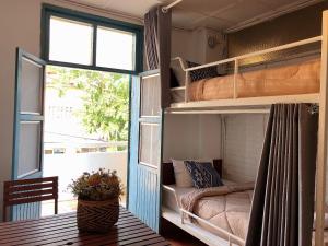 a room with two bunk beds and a window at 1918’s HOSTEL in Pakse