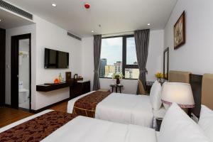 Rúm í herbergi á Golden Line Hotel Danang
