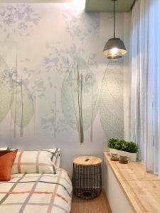 a bedroom with a bed and a table at Ho.Me-Easyhouse -II in Tainan