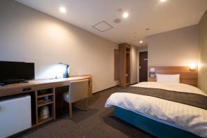 和歌山市にあるHOTEL CITY INN WAKAYAMA 和歌山駅前のベッドと机、テレビが備わったホテルの部屋 +37枚の写真