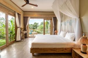 a bedroom with a bed and a balcony at Lahana Resort Phu Quoc & Spa in Phu Quoc