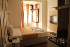 a hotel room with a bed and a window at Taksim Square Hot Residence in Istanbul