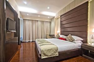 Säng eller sängar i ett rum på The Grand Bhagwati
