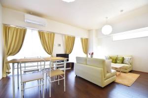 a living room with a couch and a table at Reve K 301 in Naha