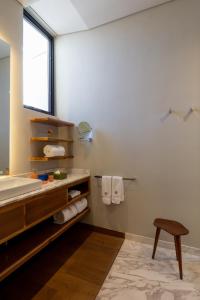 a bathroom with a tub and a sink and a stool at Central Hotel Boutique in Chihuahua +46 photos
