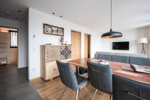 a dining room and living room with a table and chairs at naturApart in Brunico