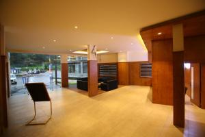 a lobby with a chair in the middle of a building at Hotel Le Sapphire in Sultan Bathery