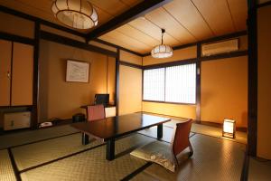 a dining room with a table and a chair at Izumiya Zenbe in Matsumoto