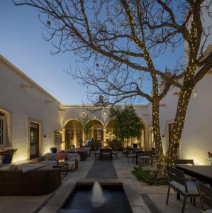a living room with a tree with lights on it at Central Hotel Boutique in Chihuahua