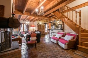 a living room with wooden ceilings and a staircase at Haras Picard Du Sant Le Chalet in Lasserre