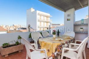 a table and chairs on a balcony with a view at Orellana in Can Picafort
