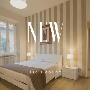 a bedroom with a bed with a new sign on the wall at Regis Condo in Siena