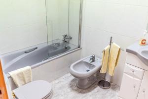a bathroom with a toilet and a shower and a sink at Casa do Pateo in Évora +20 photos