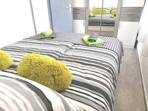 two beds with towels and pillows in a room at Apartments Regi Medulin in Medulin
