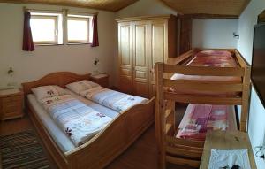 a bedroom with two bunk beds and a table at Naschthof in Dobbiaco