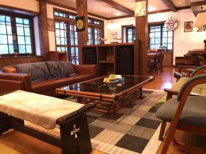 a living room with a couch and a coffee table at Pilot Lodge in Hakuba