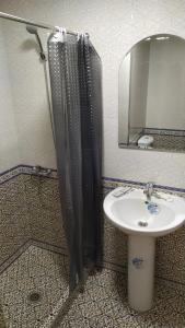 a bathroom with a shower and a sink and a mirror at Alisher B&B Hotel in Samarkand +36 photos