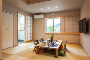 a dining room with a table and chairs at MEIBI Hakone Yumoto in Hakone