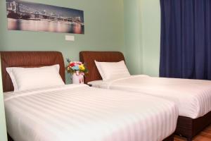 Katil atau katil-katil dalam bilik di GOOD 9 HOTEL - Bukit Dahlia
