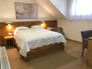 a bedroom with a large bed and a window at Plitvice Miric Inn in Plitvička Jezera