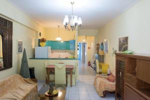 a living room with a table and a dining room at Palina's comfy home. in Kalamata
