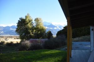 a view of mountains from the porch of a house at Mount Cook Station Shearers Quarters Lodge in Lake Tekapo