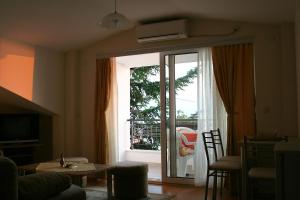 a living room with a sliding glass door to a patio at Villa Nova in Ohrid