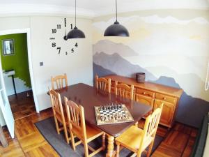 a dining room with a table with a mountain mural on the wall at Vut Carmen in Burgos
