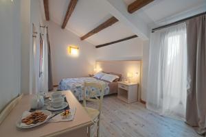 a room with a bed and a table with food on it at Palazzetto Canossa in Venice