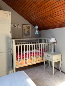 a crib in a bedroom with a wooden ceiling at Lavanda in Opatija