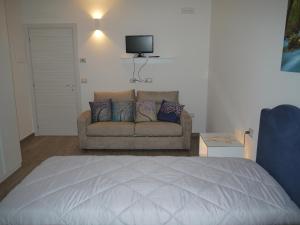 a living room with a bed and a couch at "CARA PACE" in collina - Guest House in Montefiore Conca