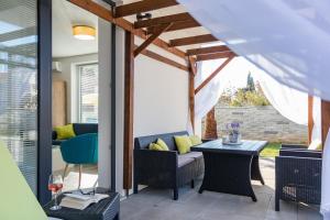 a patio with a couch and a table at Villa Cindrić in Medulin